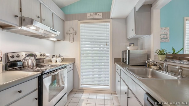 kitchen featuring dishwasher, white cabinets, sink, stainless steel electric range oven, and light tile patterned flooring