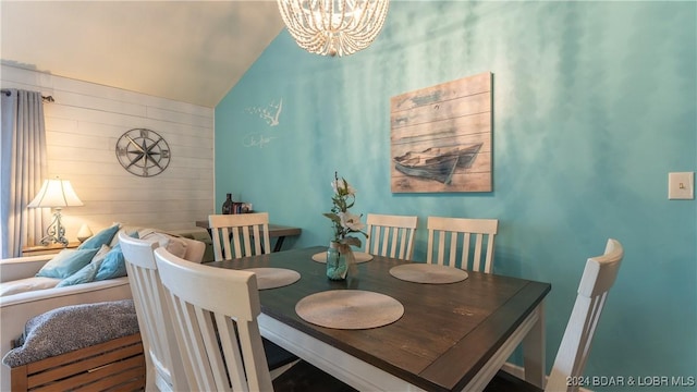 dining space featuring vaulted ceiling and a notable chandelier