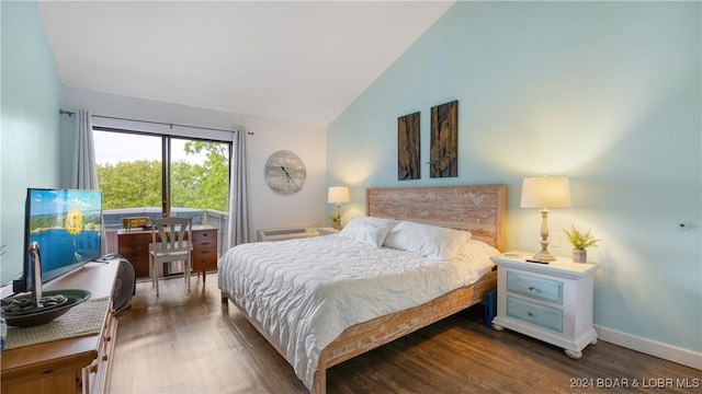 bedroom with vaulted ceiling and dark wood-type flooring