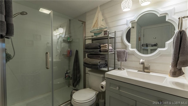 bathroom with vanity, toilet, and walk in shower