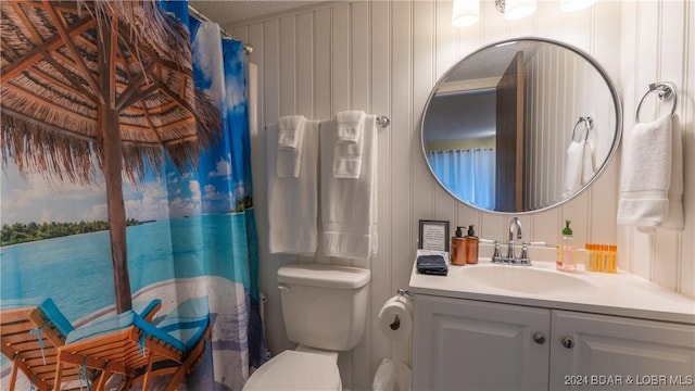 bathroom featuring a textured ceiling, toilet, wooden walls, vanity, and a shower with shower curtain