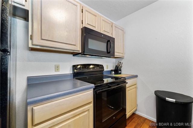 kitchen featuring black appliances, dark hardwood / wood-style floors, and light brown cabinets