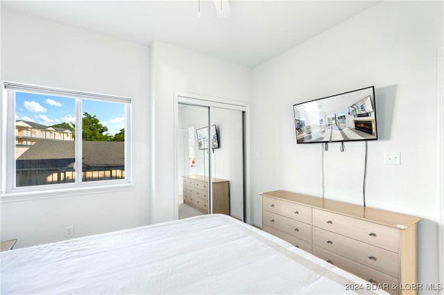 bedroom with ceiling fan and a closet