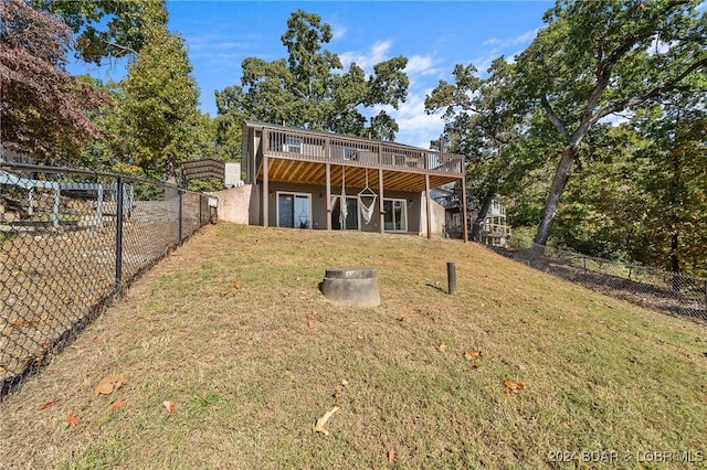 rear view of house with a yard and a deck