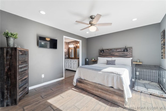 bedroom with hardwood / wood-style floors, ceiling fan, and ensuite bathroom