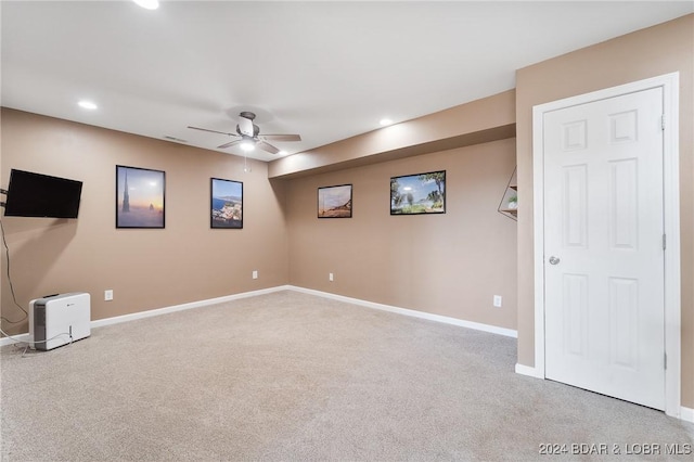 unfurnished room featuring light carpet and ceiling fan