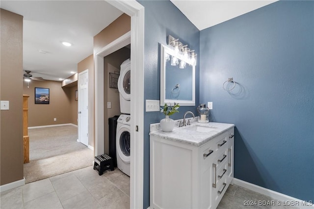 bathroom with vanity, stacked washer / drying machine, tile patterned floors, and ceiling fan