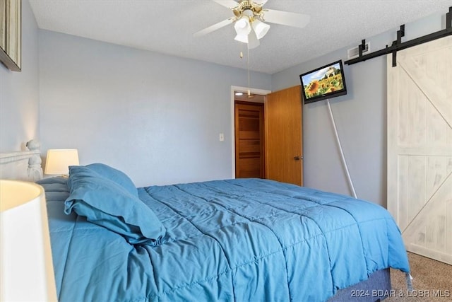 49 Casa Se Ville Dr Unit 3C-164, Lake Ozark, MO 65049 - bedroom with a barn door, carpet floors, ceiling fan, and a textured ceiling
