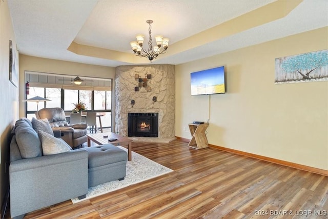 49 Casa Se Ville Dr Unit 3C-164, Lake Ozark, MO 65049 - living area with a raised ceiling, baseboards, a chandelier, wood finished floors, and a fireplace