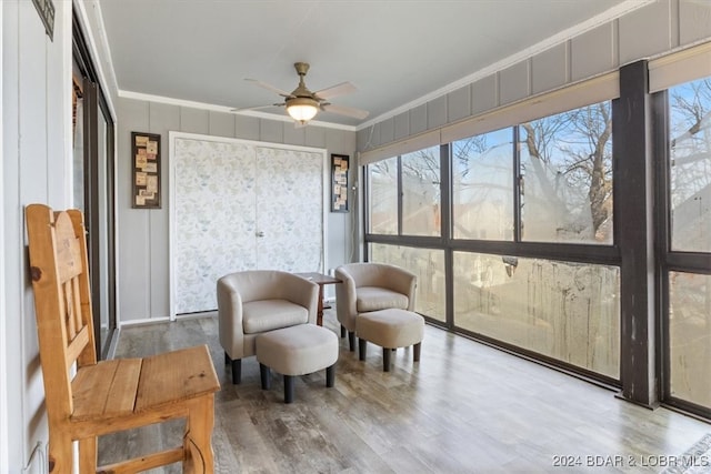 sunroom featuring ceiling fan