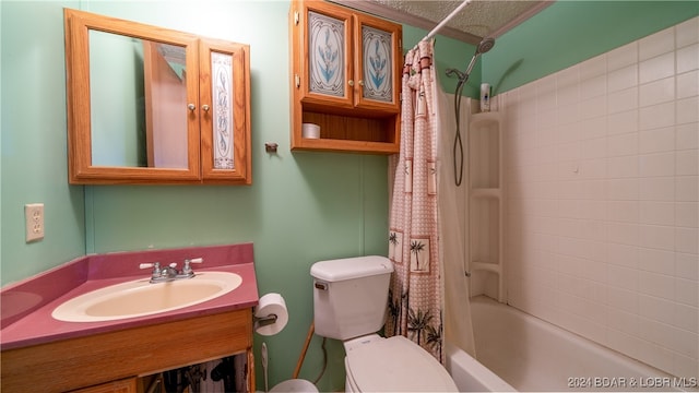 full bathroom with a textured ceiling, vanity, shower / bath combo, and toilet