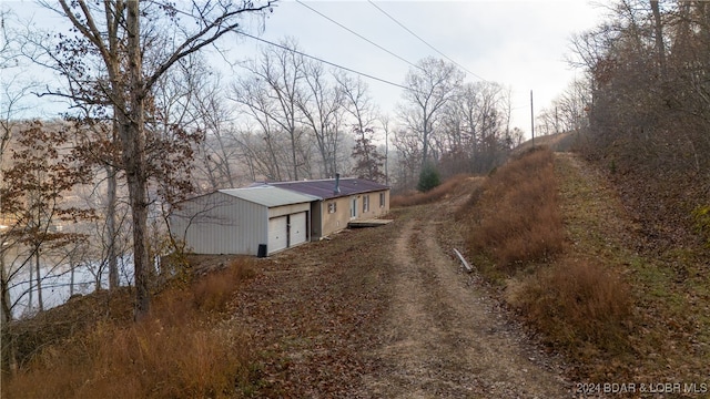 view of property exterior featuring a garage and an outdoor structure