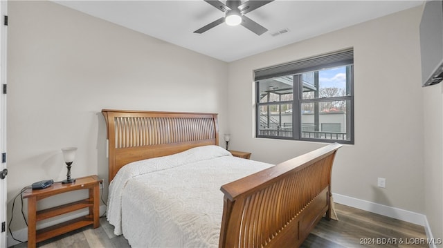 bedroom with ceiling fan and wood-type flooring