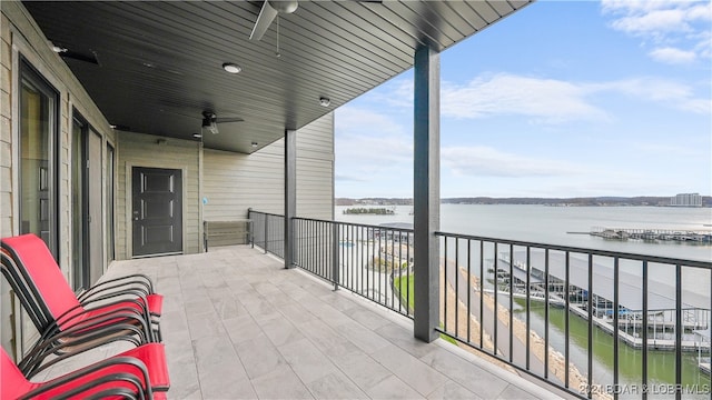 balcony with a water view and ceiling fan