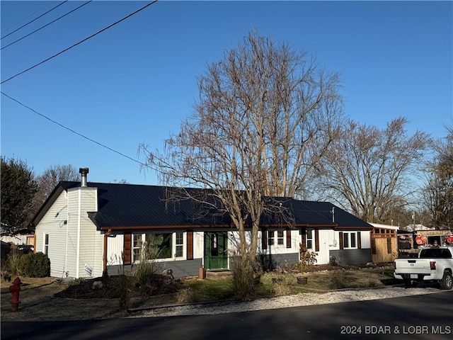 single story home with solar panels