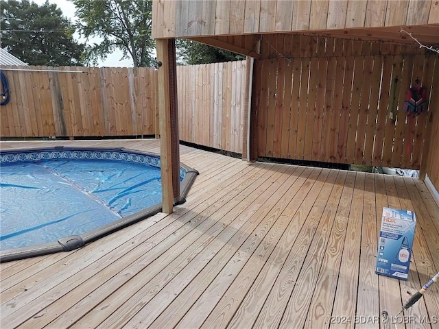 view of swimming pool with a wooden deck