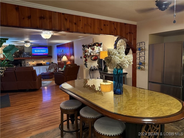 dining area featuring hardwood / wood-style flooring, ceiling fan, and ornamental molding