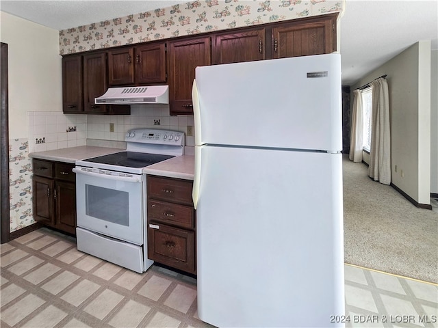 kitchen with backsplash, dark brown cabinets, and white appliances