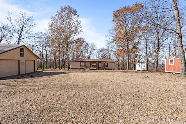 view of yard featuring a garage and a shed