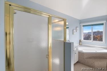 bathroom with separate shower and tub