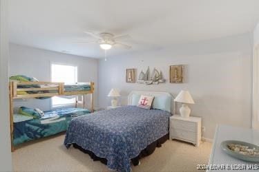 bedroom featuring ceiling fan and light carpet