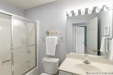 full bathroom with vanity, toilet, and enclosed tub / shower combo