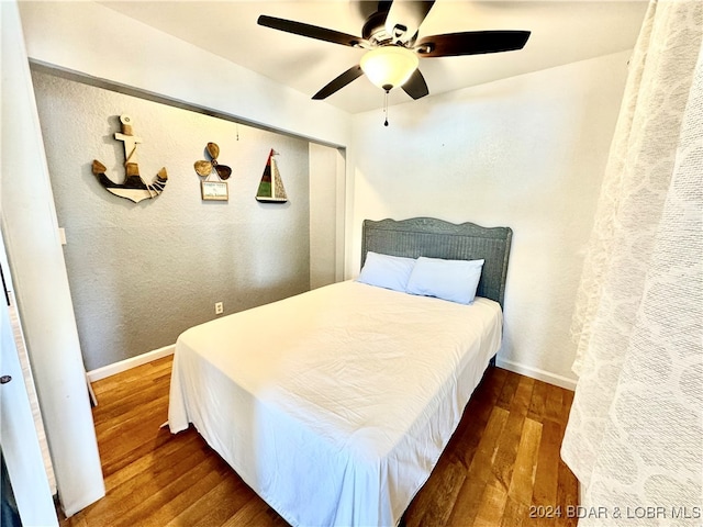 bedroom featuring dark hardwood / wood-style flooring and ceiling fan