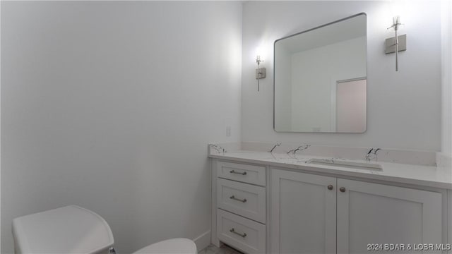 half bathroom with vanity and toilet