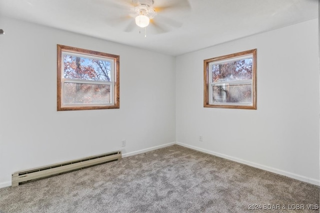 empty room featuring light carpet, ceiling fan, and a baseboard heating unit