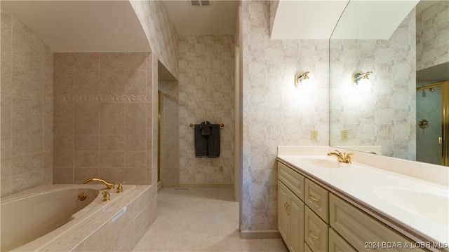 bathroom with tile patterned flooring, vanity, and independent shower and bath