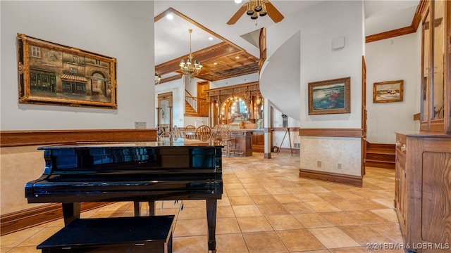 misc room with crown molding, a towering ceiling, light tile patterned floors, and ceiling fan with notable chandelier