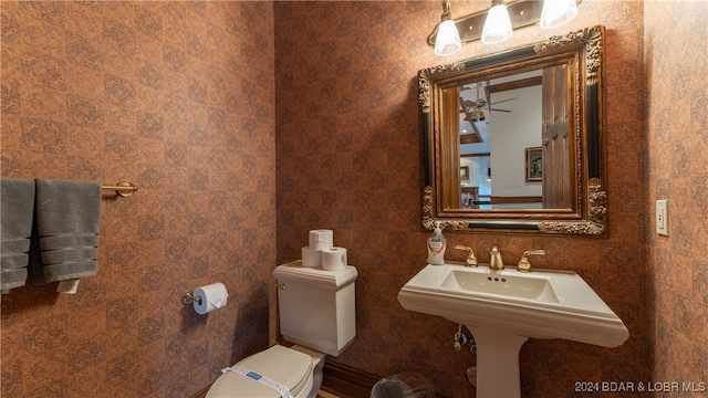 bathroom featuring toilet, tile walls, and ceiling fan