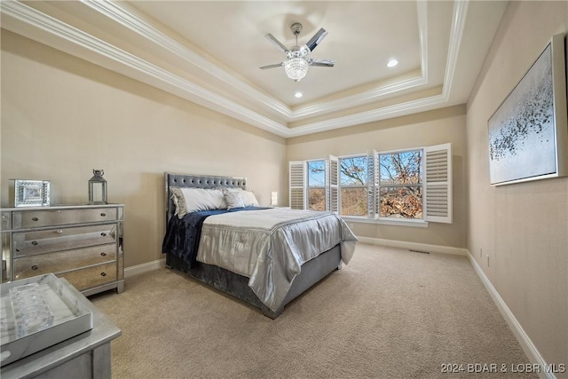 bedroom with a tray ceiling, ceiling fan, carpet floors, and ornamental molding