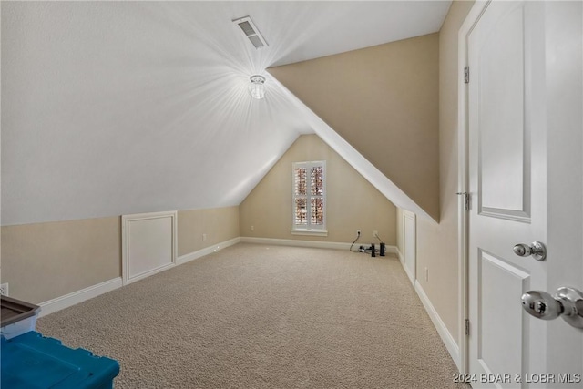 bonus room with carpet flooring and lofted ceiling