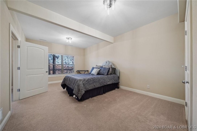 carpeted bedroom with beamed ceiling