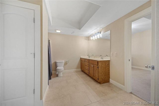 bathroom with tile patterned flooring, vanity, and toilet