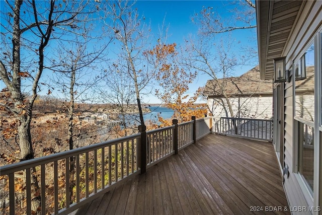 wooden deck featuring a water view