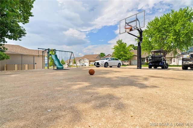 view of sport court featuring a playground