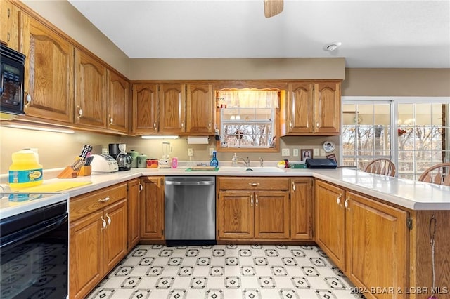 kitchen with kitchen peninsula, sink, and black appliances