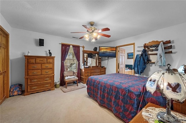 bedroom featuring ceiling fan, carpet floors, and a textured ceiling