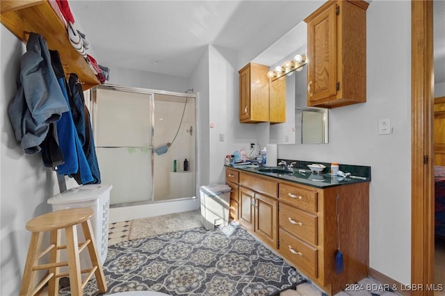 bathroom with vanity and a shower with shower door