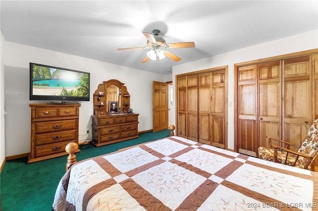 carpeted bedroom with ceiling fan and two closets