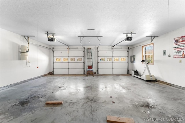 garage with electric panel and a garage door opener