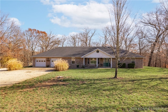 ranch-style house featuring a garage and a front lawn