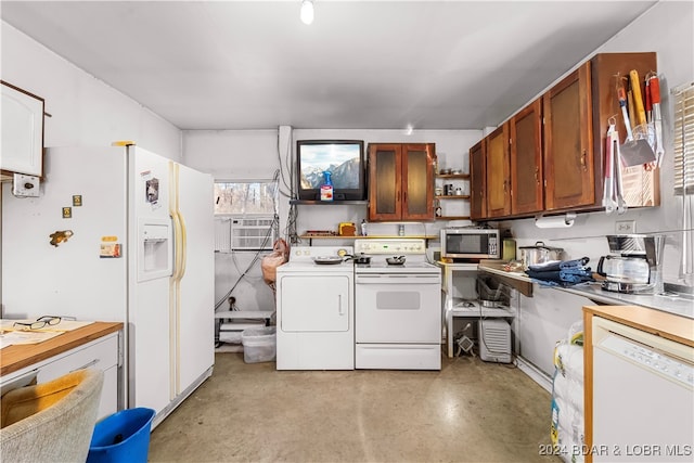 kitchen with a wall mounted air conditioner, washer and dryer, and white appliances