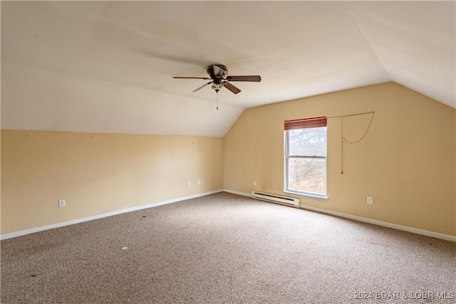 additional living space with carpet flooring, vaulted ceiling, ceiling fan, and a baseboard heating unit