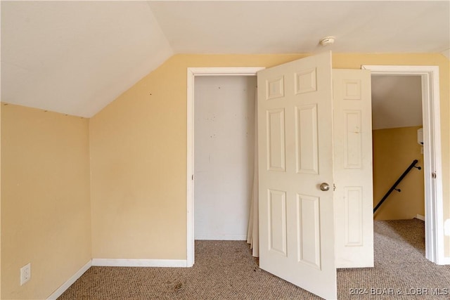 bonus room featuring carpet and vaulted ceiling