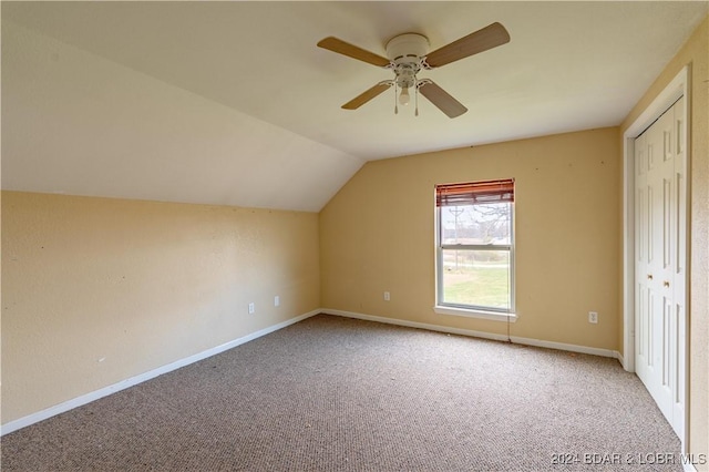 additional living space with ceiling fan, carpet floors, and vaulted ceiling