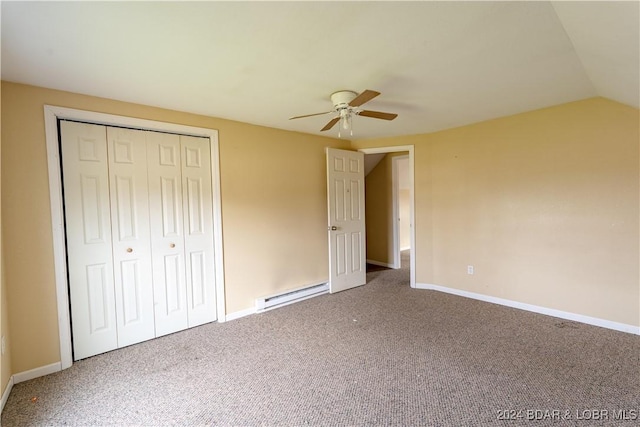 unfurnished bedroom with ceiling fan, a baseboard heating unit, carpet floors, a closet, and lofted ceiling