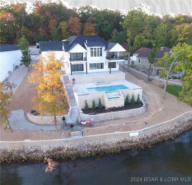 birds eye view of property with a water view